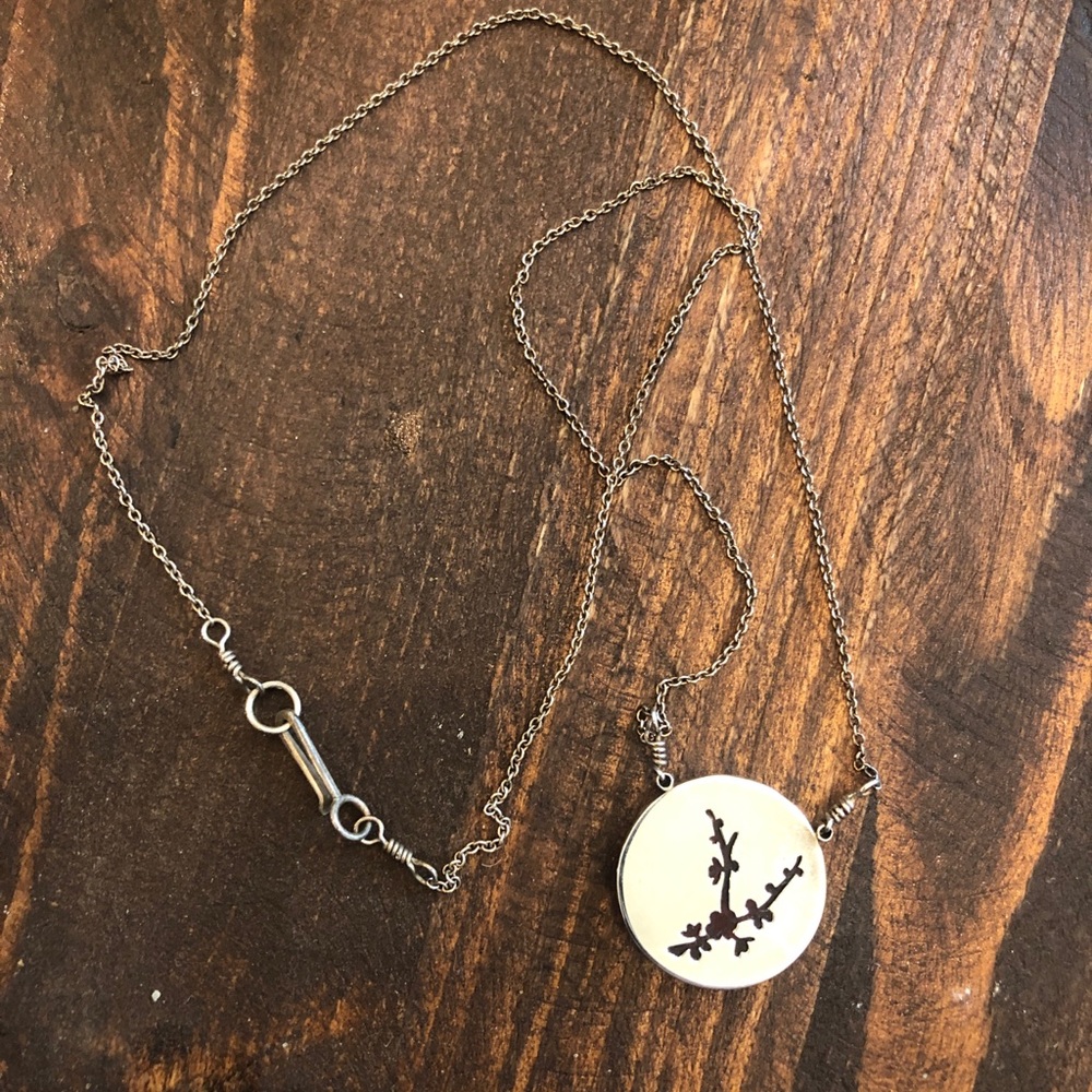 Silver necklace with red glass flower detail